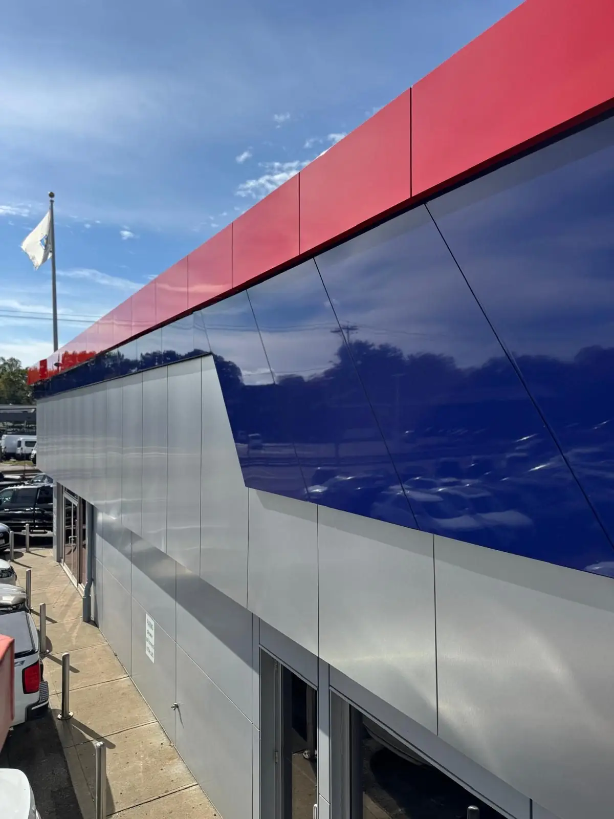 Red, navy and silver ACM facade at an automotive building in Framingham