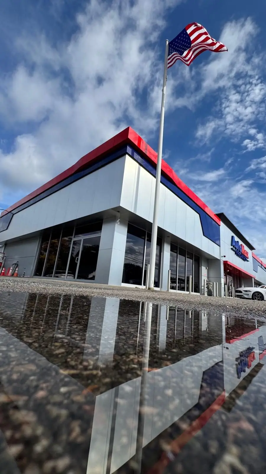 Corner of the Automax building with ACM cladding and the U.S. flag, Framingham
