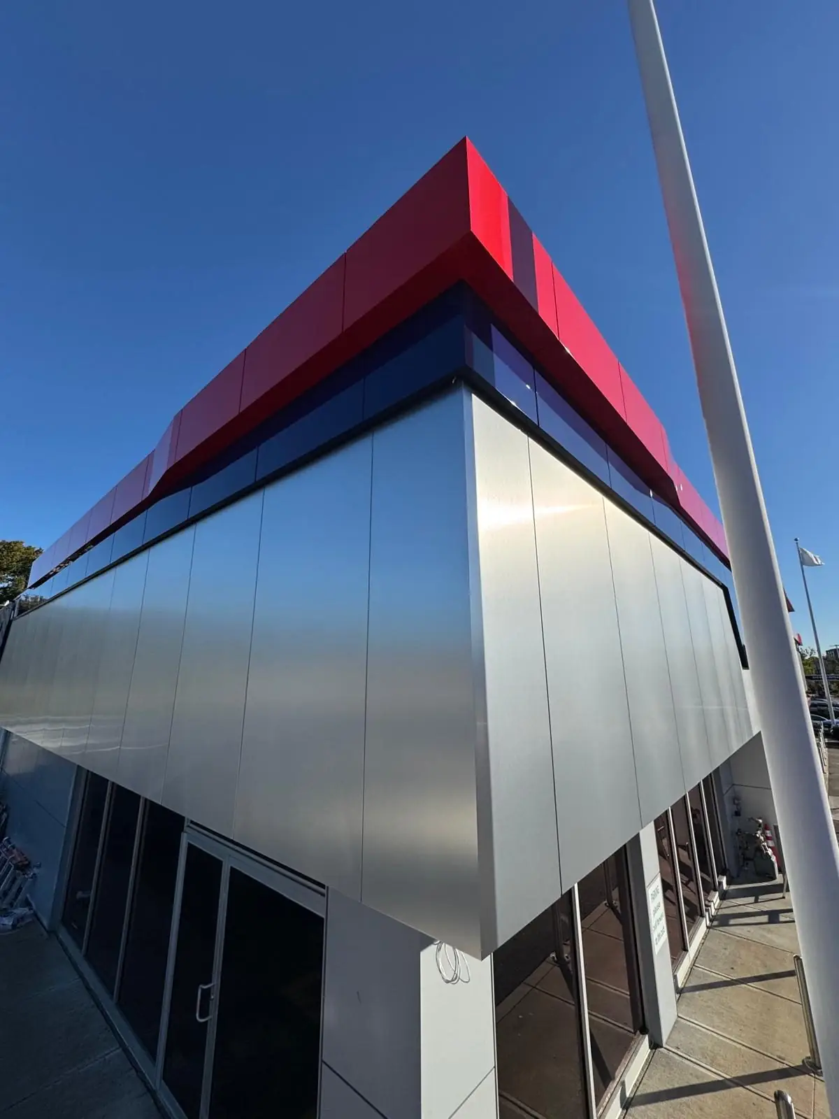 Silver and red ACM corner detail at the Automax building in Framingham