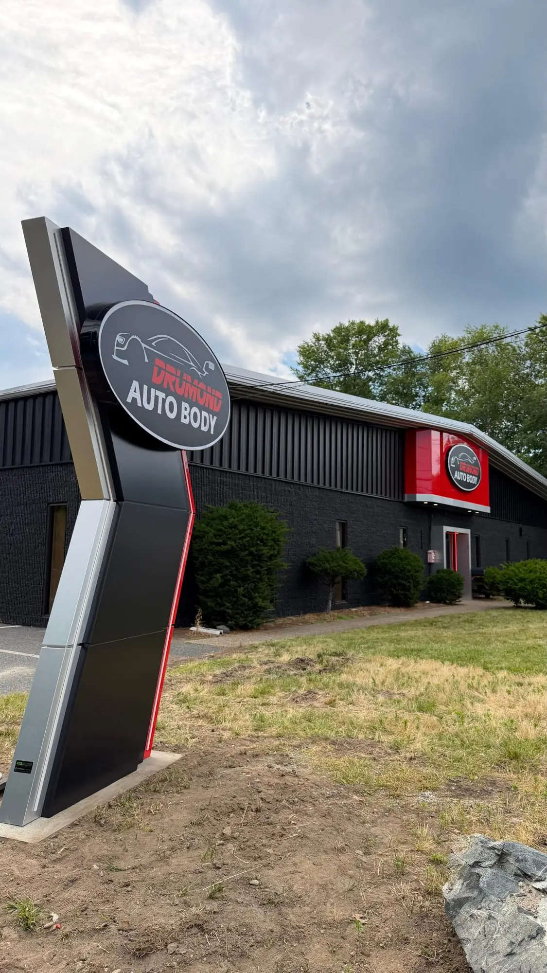 Drumond Auto Body totem sign beside the building, Framingham