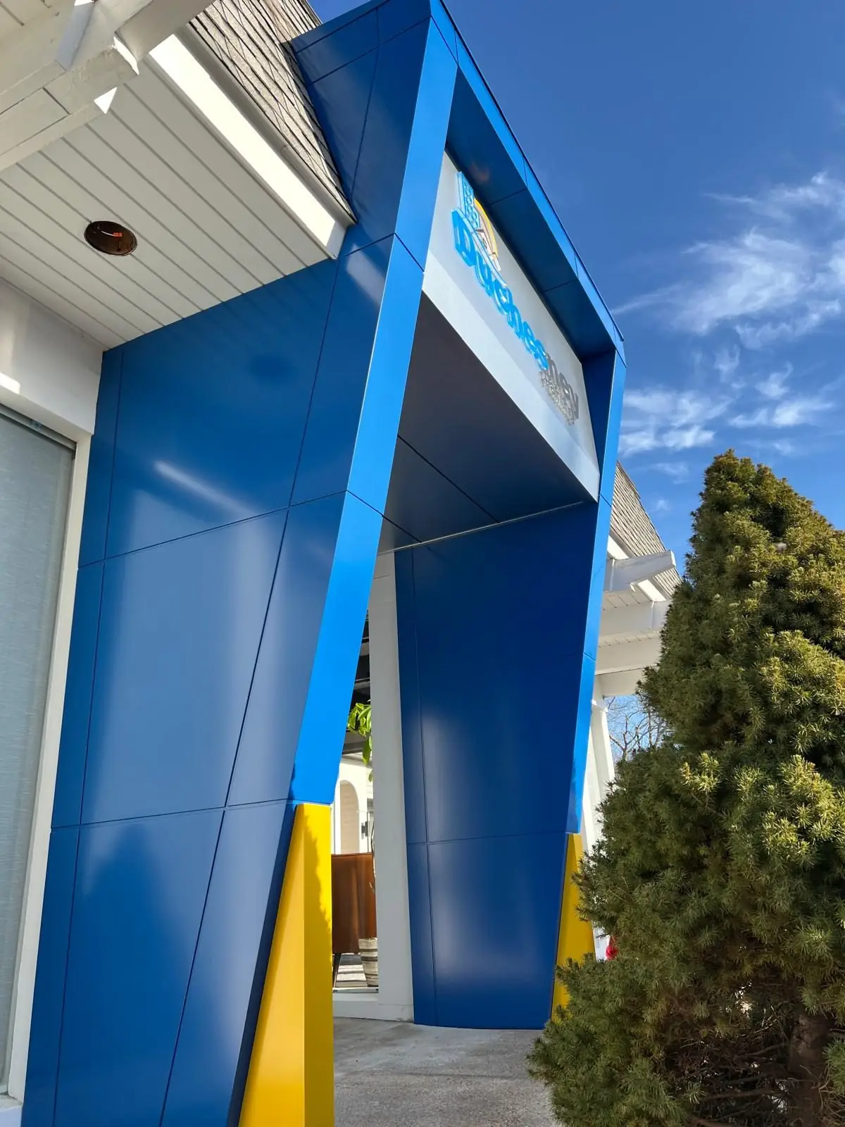 Angled blue ACM portal with yellow base accent, Hyannis