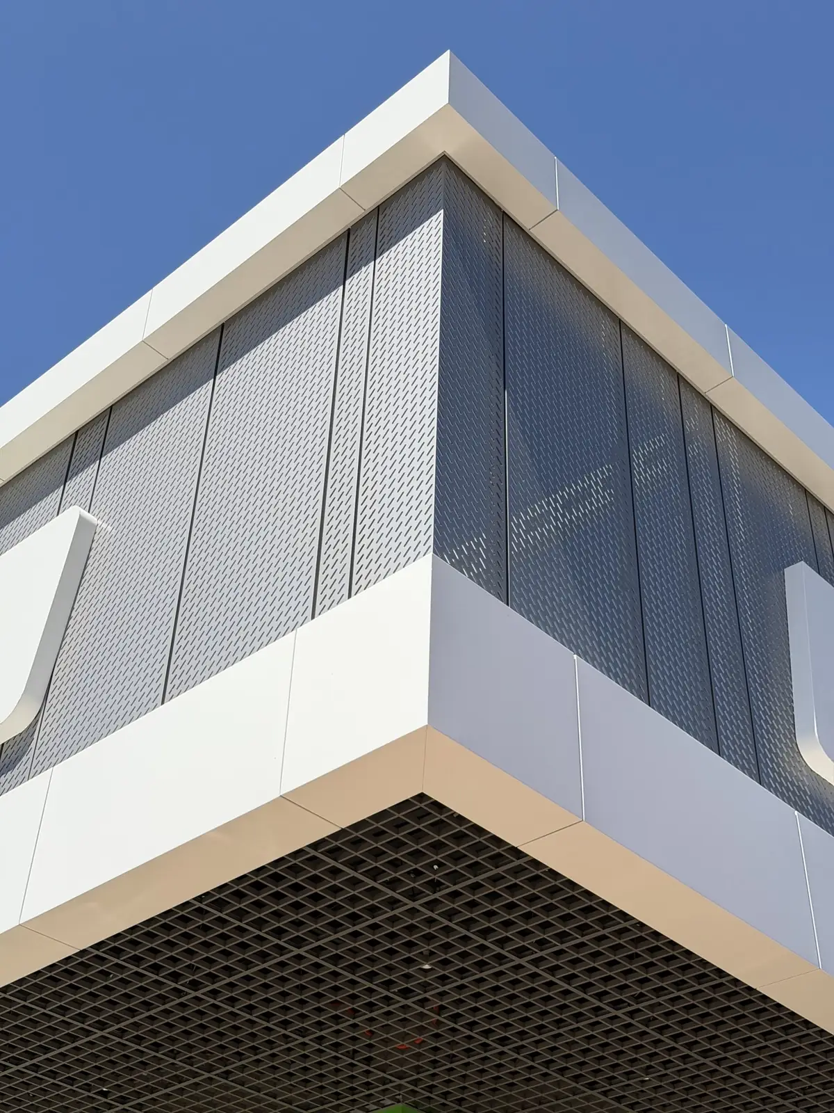 Corner junction of perforated and solid ACM panels