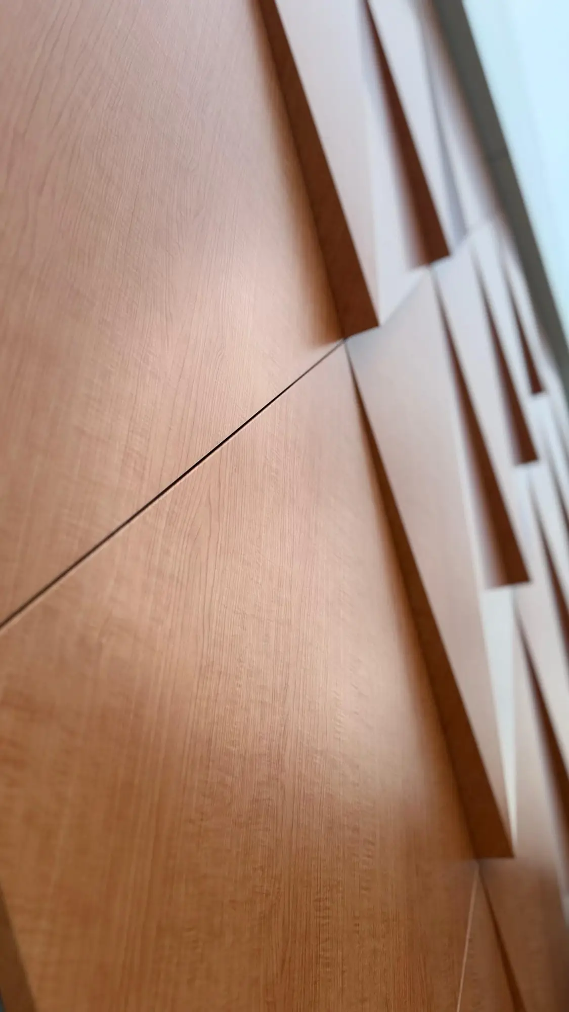 Wood-look ACM panels with three-dimensional diamond relief on a building facade in Boston