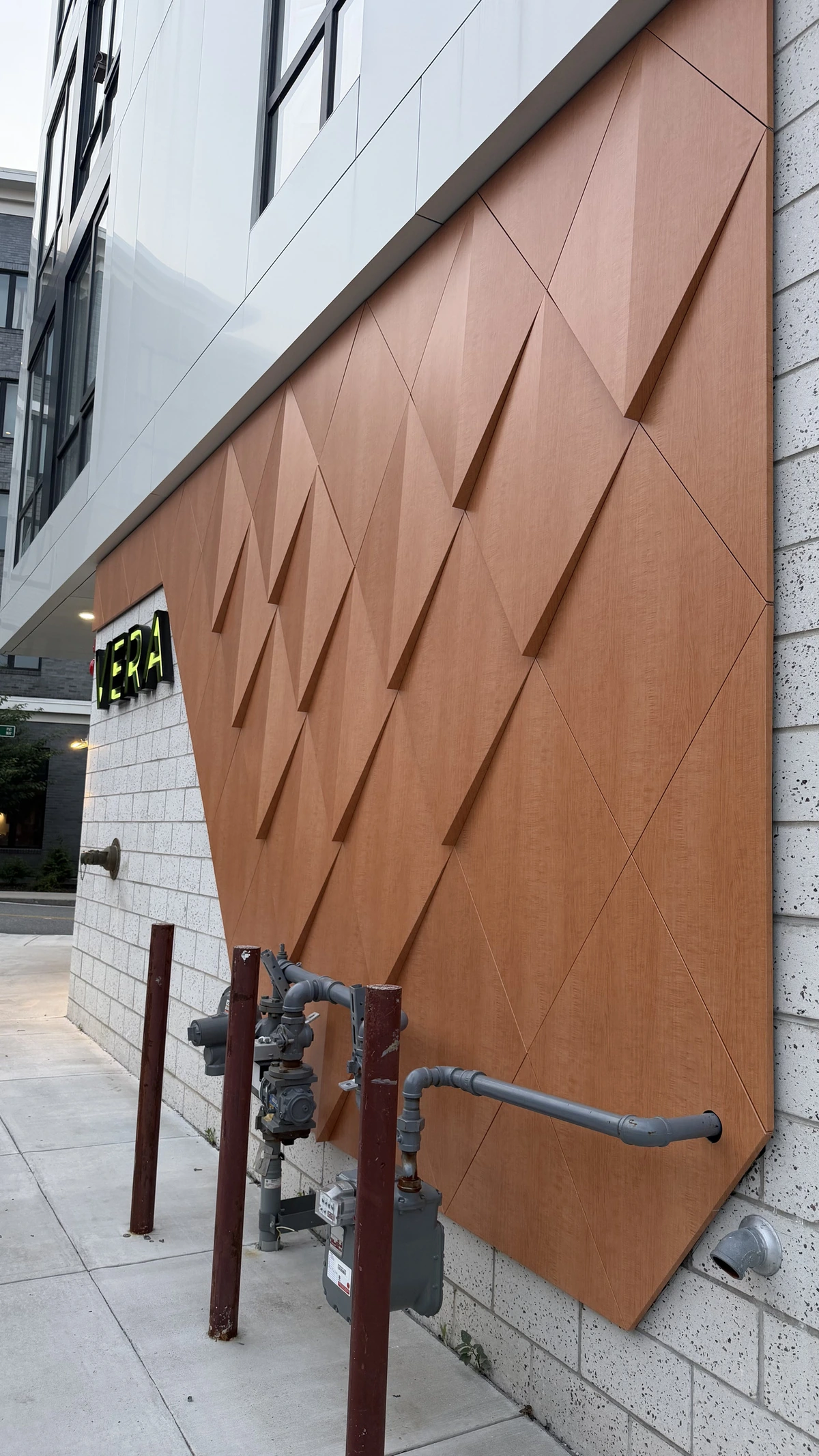 Faceted wood-look ACM wall beside the VERA sign, Boston